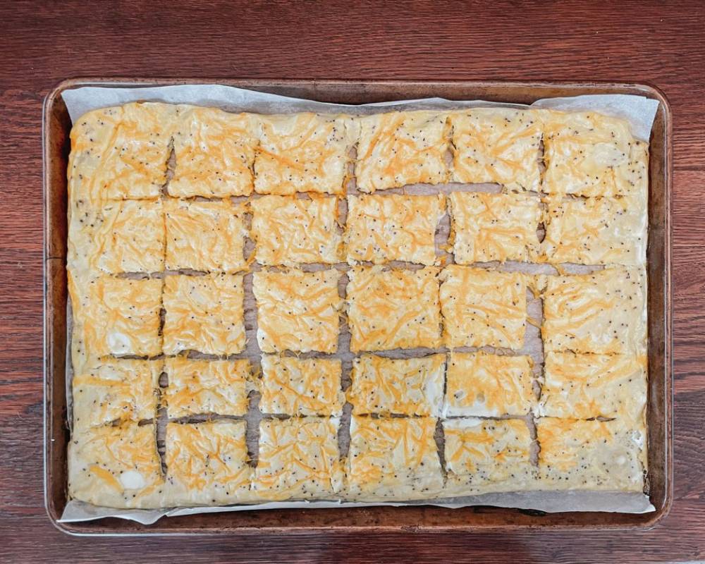 oven baked eggs cut into squares on a sheet pan on a wooden table